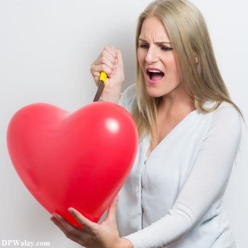 a woman holding a red heart balloon sad heart dp 