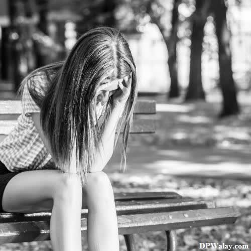 a young girl sitting on a bench in the park sad instagram dp 