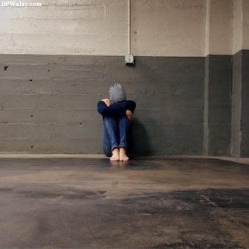 sad girl dp - a woman sitting on the floor in an empty room
