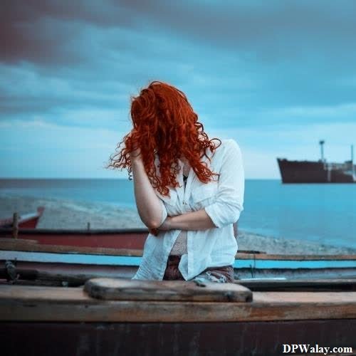 a woman sitting on a boat looking out at the ocean simple whatsapp dp 