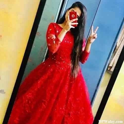 single girl dp - a woman in a red dress standing in front of a mirror