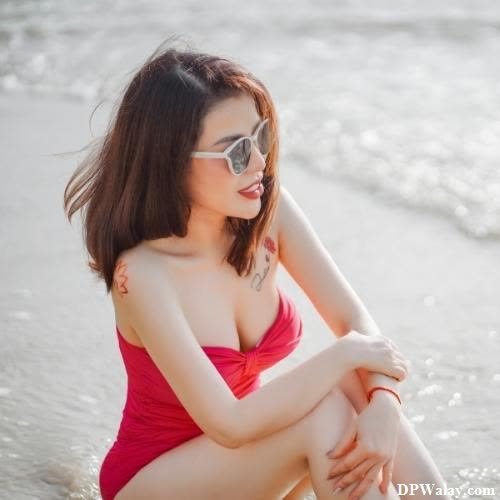 a woman in a red dress sitting on the beach single dp for girl