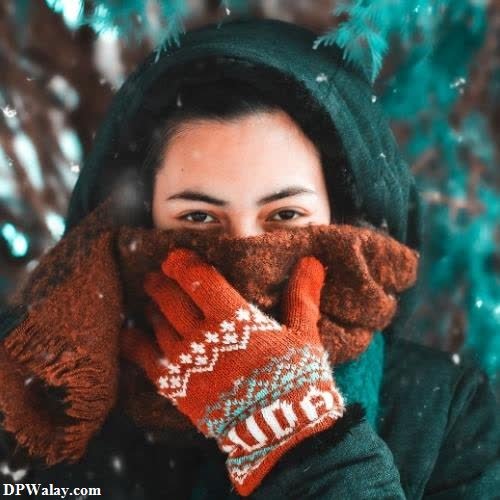 a woman wearing a scarf and mits in the snow images by DPwalay