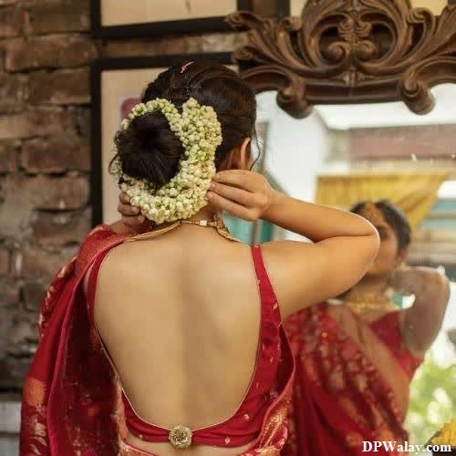 a woman in a red sari with a flower in her hair single pic for dp 
