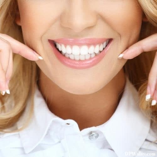 a woman with blonde hair and white teeth