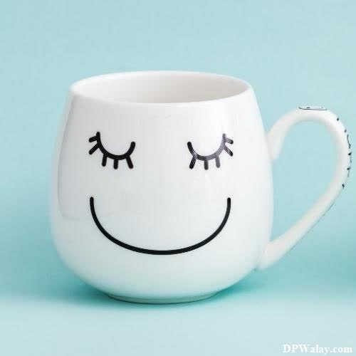 a white mug with a smiley face painted on it