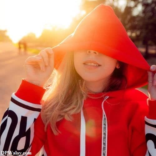 a girl in a red hoodie and sunglasses
