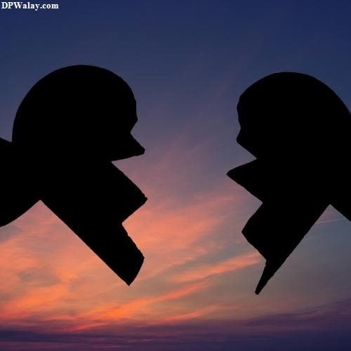 two silhouettes of a man and woman facing each other silhouettes of a man and woman facing