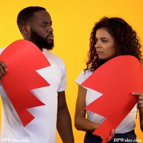 sad girl dp - a man and woman holding up a red heart