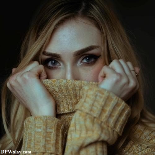 unique trendy dp for instagram - a woman with long blonde hair and blue eyes, covering her face with her hands