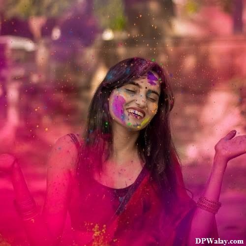 a woman is covered in colored powder