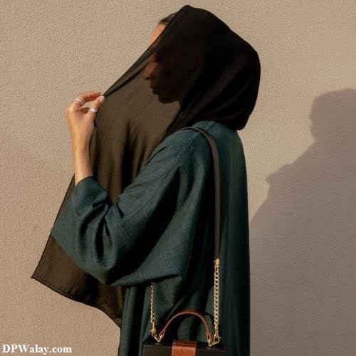 a woman in a hina with a brown purse