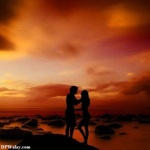 a couple kissing on the beach at sunset unik dp 
