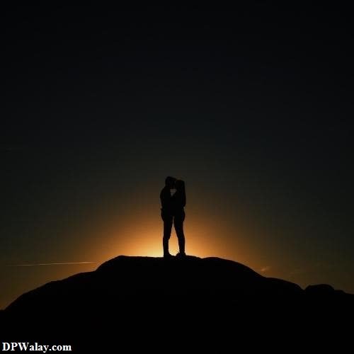 a silhouette of a couple kissing on a mountain at sunset unique dp images