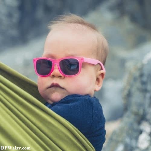 a baby wearing sunglasses and a green blanket unique dps