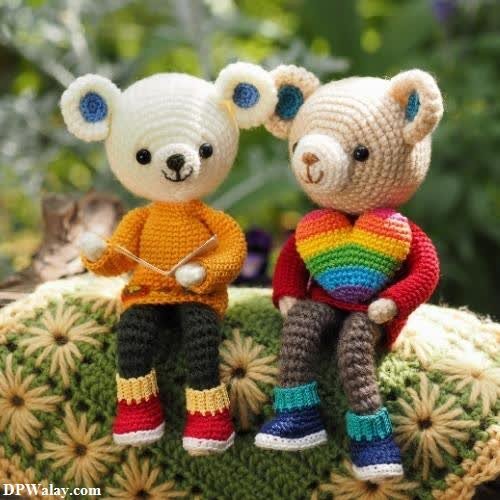 unique dp for whatsapp - two stuffed bears sitting on a rock with a rainbow colored shirt