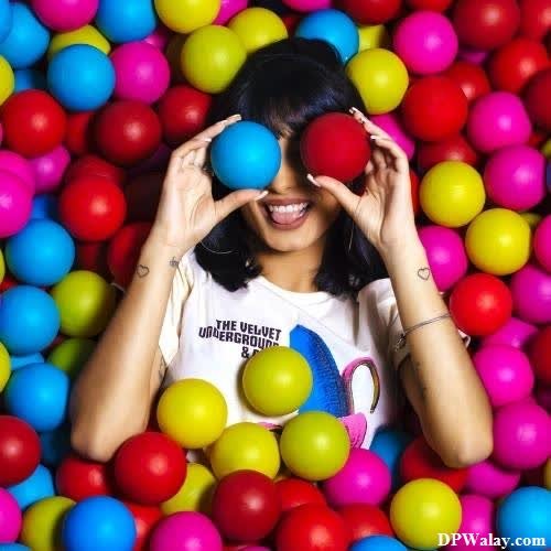 a woman in a ball pit with her hands on her face unique images for whatsapp dp