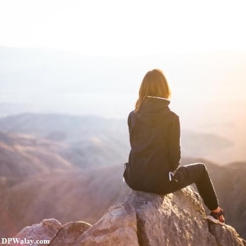 a woman sitting on top of a mountain looking out at the mountains unique images for whatsapp dp 
