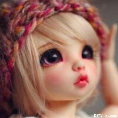 unique dp for whatsapp - a doll with a pink hat on her head