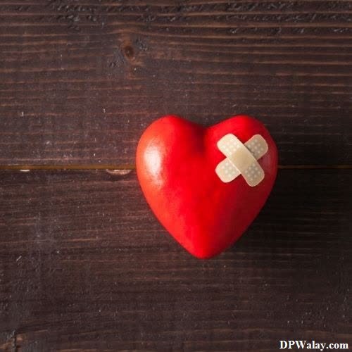 a red heart with a bandage on it whatsapp broken heart dp