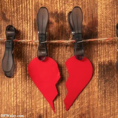 broken dp for whatsapp - two red hearts hanging on a clothes line