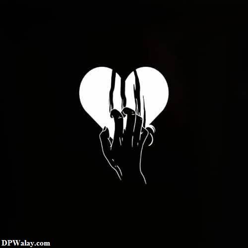 a black and white image of a hand holding a heart 