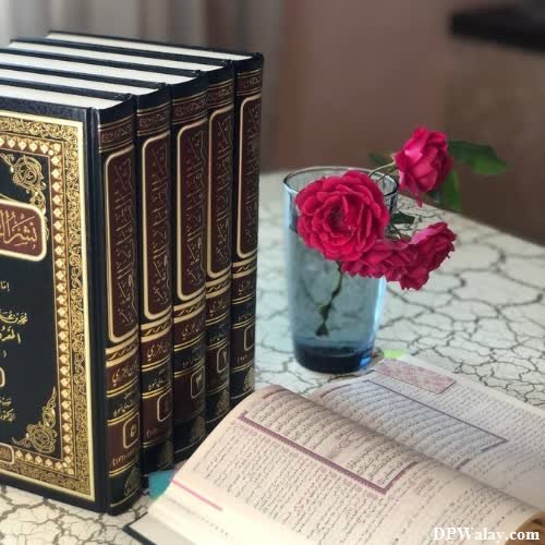 a book and a vase on a table whatsapp dp for islamic 