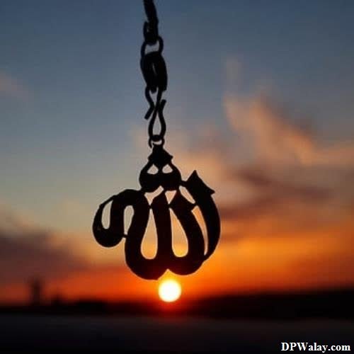 a silhouette of a person holding a chain with the sun setting in the background whatsapp dp images islamic