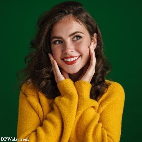 a woman in a yellow sweater posing for a photo 