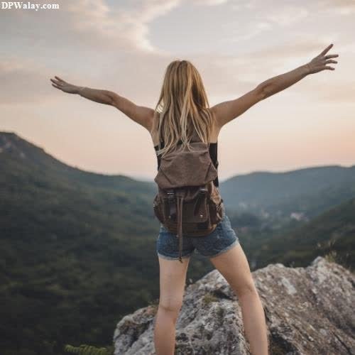 a woman standing on top of a mountain whatsapp dp unique 