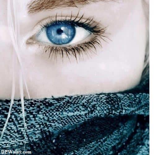 a woman with blue eyes and scarf