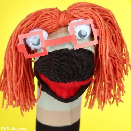 a sock sock doll with a red nose and red hair