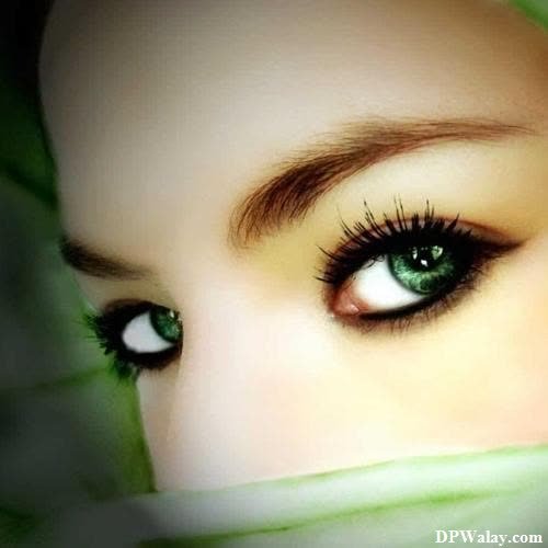 a woman with green eyes and a green scarf