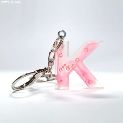 a pink letter k keychai with a silver ring