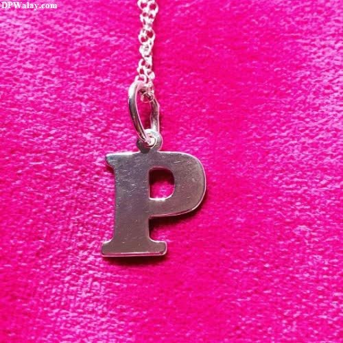 a silver initial necklace with the letter p on it 