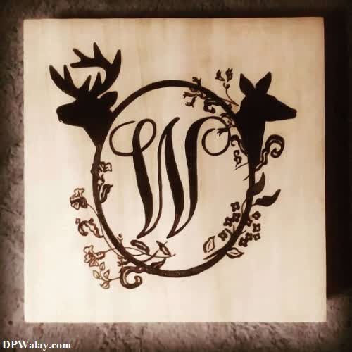 a wooden sign with a deer and a bird
