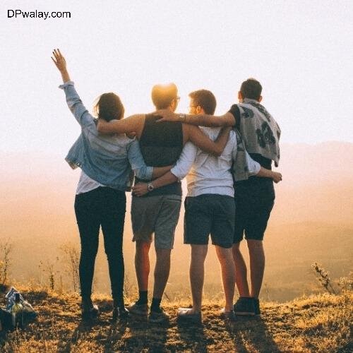 three people standing on top of a hill with their arms around each other people