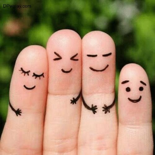 two fingers with smiley faces drawn on them 