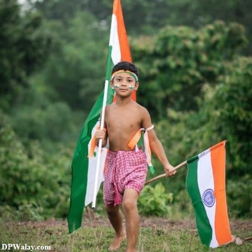 a young boy holding the indian flag