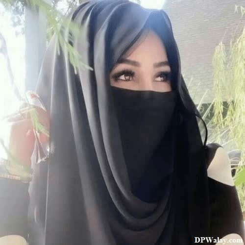 a woman wearing a black veil and a black head scarf-N8dq