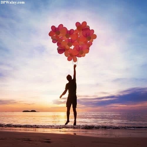 Modern Cute Couple DP - a person holding up balloons on the beach