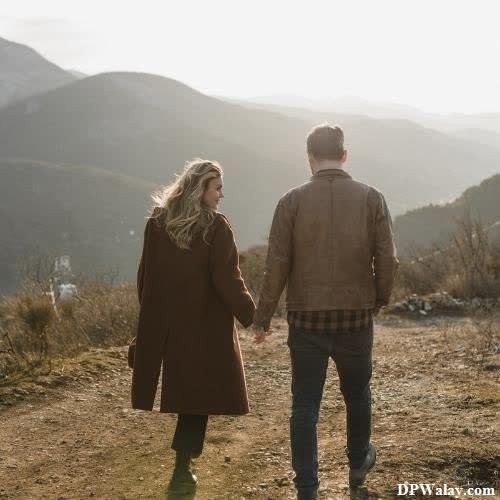 a couple walking down a path in the mountains caring couple dp 