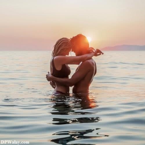 a woman sitting in the water at sunset couple dp romantic 