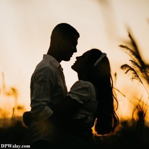 a couple in the sunset at their engagement couple romantic dp