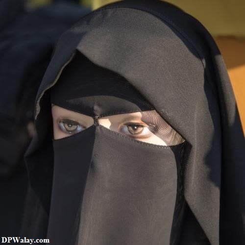 a woman wearing a black veil and a black head scarf