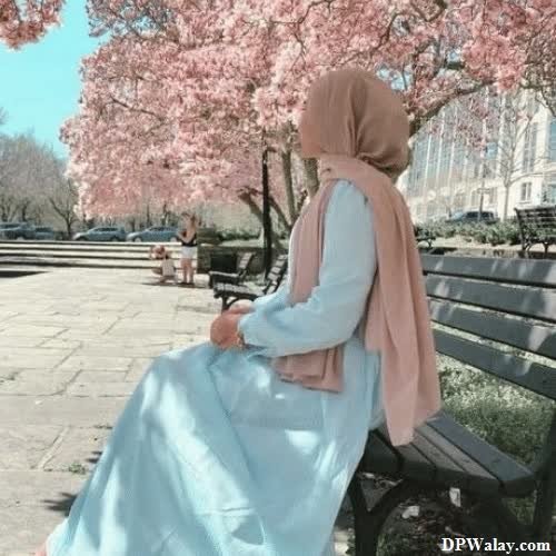 a woman sitting on a bench in a park cute hijab girl dp 
