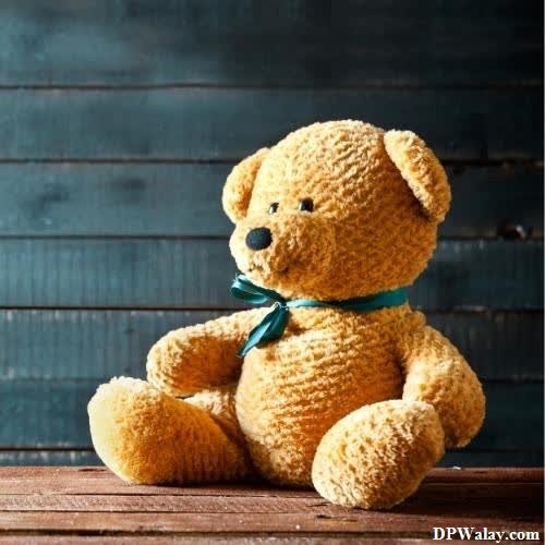 a teddy bear sitting on a wooden table-cNWr