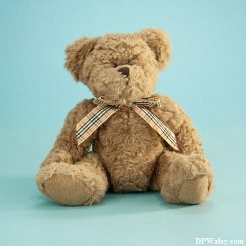 a teddy bear sitting on a blue background images by DPwalay