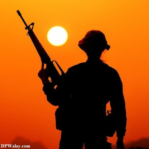 a soldier stands guard at sunset 