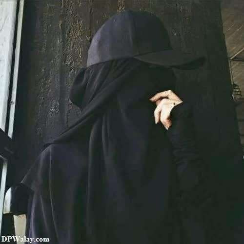 a person in a black cloak with a hood on